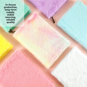 Macro shot of assorted colorful plush A5 notebooks with soft faux fur texture and bookmarks