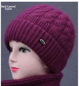 Detailed cable knit texture of deep wine red winter hat with metal logo plate