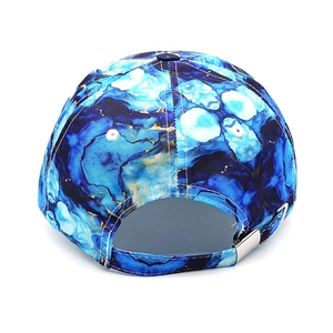 Detail view of tie-dye baseball cap with blue marble pattern and metal buckle closure