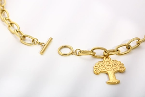 Detail shot of golden heart tree of life pendant bracelet with T-bar toggle clasp