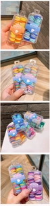 Close-up of colorful elastic hair bands in a transparent box for toddlers and kids