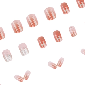 Pink gradient press-on nails with silver glitter and metal H logo accents
