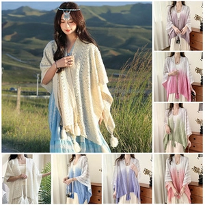 Detail of white hollow knit shawl showing exquisite craftsmanship and tassel hem