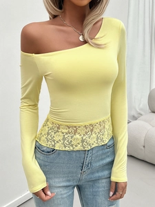 Close-up of asymmetrical off-shoulder neckline and lace stitching on long sleeve top