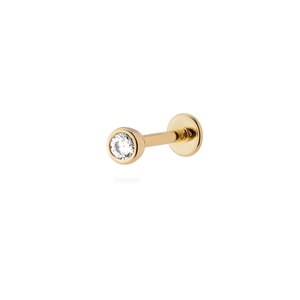 Detailed view of a gold flat back labret stud earring with a clear round zircon stone