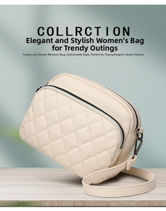 Detail of beige quilted crossbody bag with metal zipper and adjustable strap on wood