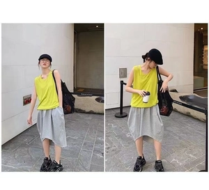Detail of a sheer black mesh tote bag paired with a lime green top and grey skirt
