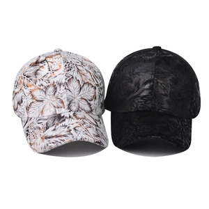 Black and white baseball caps featuring artistic leaf patterns for outdoor sun protection