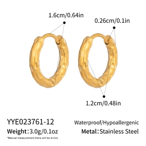 Macro shot of hammered 18K gold plated stainless steel hoops with 1.6cm outer diameter