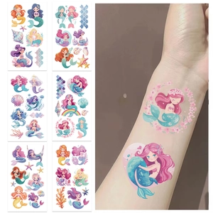 Waterproof cartoon mermaid temporary tattoos for kids shown on paper and applied to arm