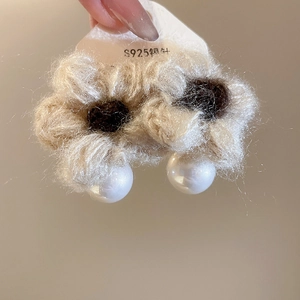 Detailed close-up of knitted floral earrings with pearls and S925 silver needles