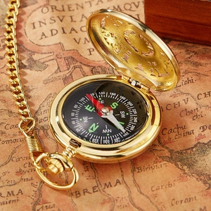 Golden flip cover compass pocket watch with chain on a vintage nautical map background