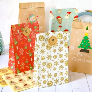Set of 12 Christmas Kraft paper gift bags with festive stickers for holiday candy packing