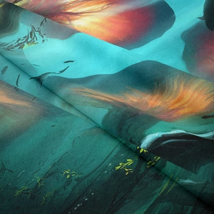 Close-up of silky bohemian tapestry fabric showing vivid abstract mountain print