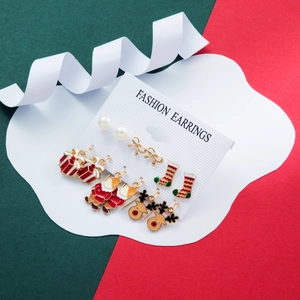 Close-up of 5-pair Christmas earring set with Santa Claus and reindeer on festive cards