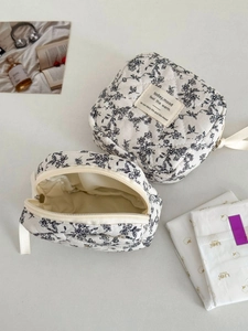 Detail of floral quilted storage bag showing the zipper closure and soft inner lining
