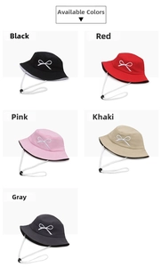Detail view of cotton bucket hats in five colors featuring white bow embroidery and wind ropes