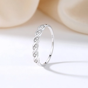 S925 sterling silver stackable twist ring with sparkling zircon stones on white background