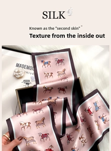 Detail of premium pink silk scarf featuring elegant horse print and contrast border