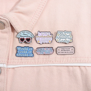 Set of 6 colorful enamel pins featuring inspirational quotes on a pink denim jacket