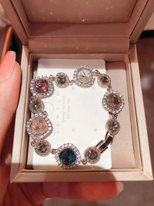 Detail of 925 silver bracelet featuring multi-colored gemstones with halo diamond settings