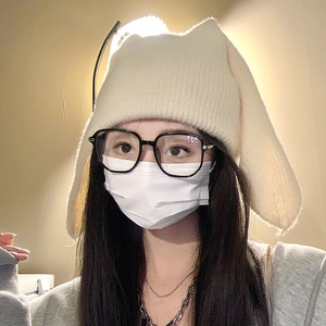 Cute beige knit beanie with long bunny ears for women, cozy winter fashion style
