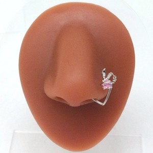 Macro shot of silver nose stud with pink heart gem and clear stones on nose model