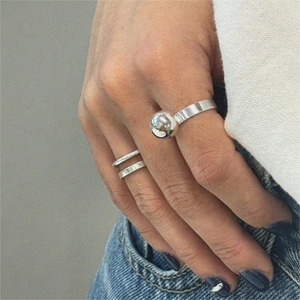 Detail of 925 sterling silver ball ring and double-layer band worn on a finger