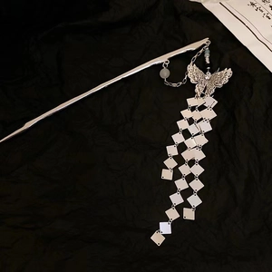 Elegant silver butterfly hair pin with long tassel in a minimalist traditional style