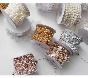 Assorted Christmas bead chains and star garlands in gold silver and white for DIY decor