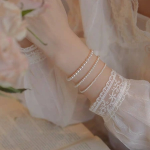 Three-layer round pearl bracelet set in 14k gold finish for an elegant stacked look