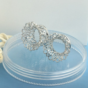 Hollow flower silver ear tunnels with intricate circular lace design for body piercing