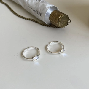 Adjustable S925 sterling silver ring with oval moonstone on white background