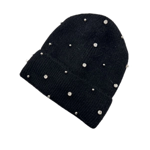 Detailed view of black knitted beanie featuring sparkling rhinestones on soft fabric