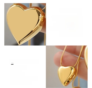 Detail of 18K gold-plated heart pendant on a sleek snake chain made of surgical steel