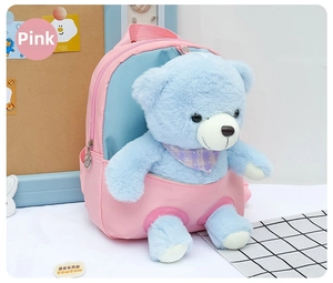 Detail of pink and blue kids backpack with cute plush bear and soft fabric texture