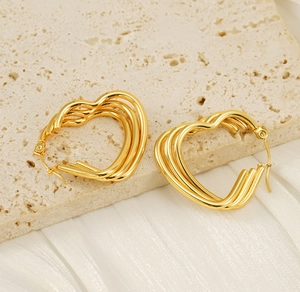 Detailed macro view of triple-layered heart earrings in 18K gold-plated stainless steel
