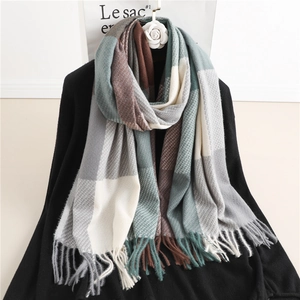 Detail of soft plaid scarf with tassels in forest green, brown and grey tones