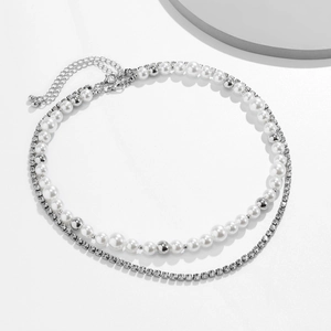 Double-layered necklace with faux pearls, silver beads, and rhinestone chain on white background