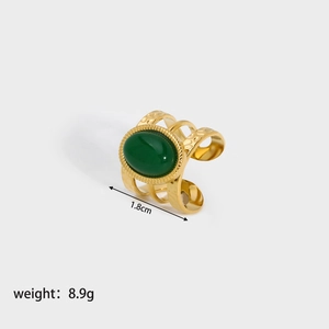 Detail shot of vintage green stone ring with textured gold band showing 1.8cm diameter