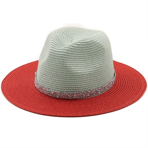 Detail of grey and red bicolor straw panama hat with glitter ribbon trim on white background