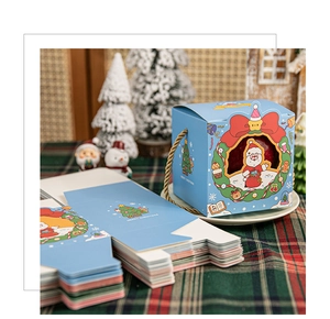 Close-up of light blue Christmas gift boxes featuring Santa Claus and hemp rope handles