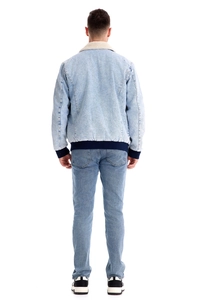 Rear view of men's blue denim jacket with white fleece collar and ribbed knit cuffs