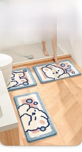 Detailed close-up of soft flocking bathroom mats with cute rabbit and bubble patterns