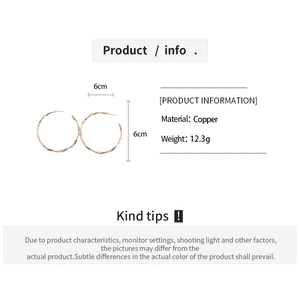 Detailed view of 6cm copper hoop earrings with twisted texture in rose gold finish