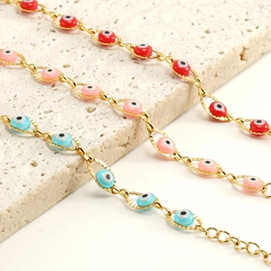 Golden stainless steel evil eye bracelets with colorful charms on white stone base
