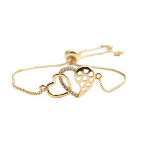Detail of gold-plated double heart interlocking bracelet with sparkling zircon stones