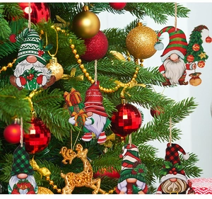 Detailed view of wooden Christmas gnome ornaments hanging on a decorated festive tree