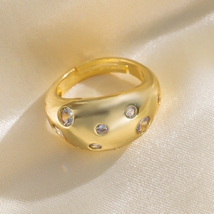 Fashion gold copper open ring with zircon inlay on warm silk background