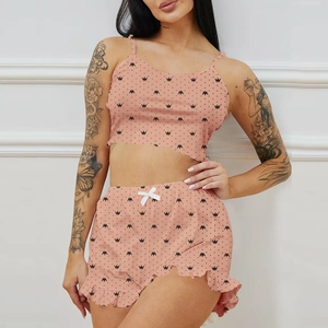 Women's two-piece pink pajama set with crown print, camisole top and ruffled shorts